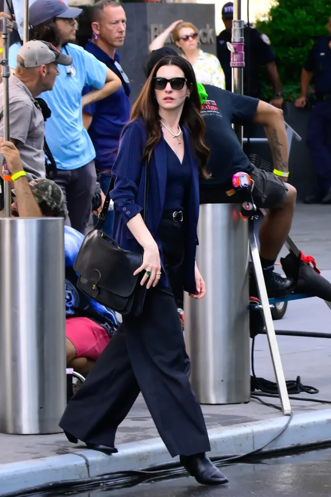 Anne Hathaway carrying the vintage Coach Metropolitan Briefcase in The Devil Wears Prada 2
